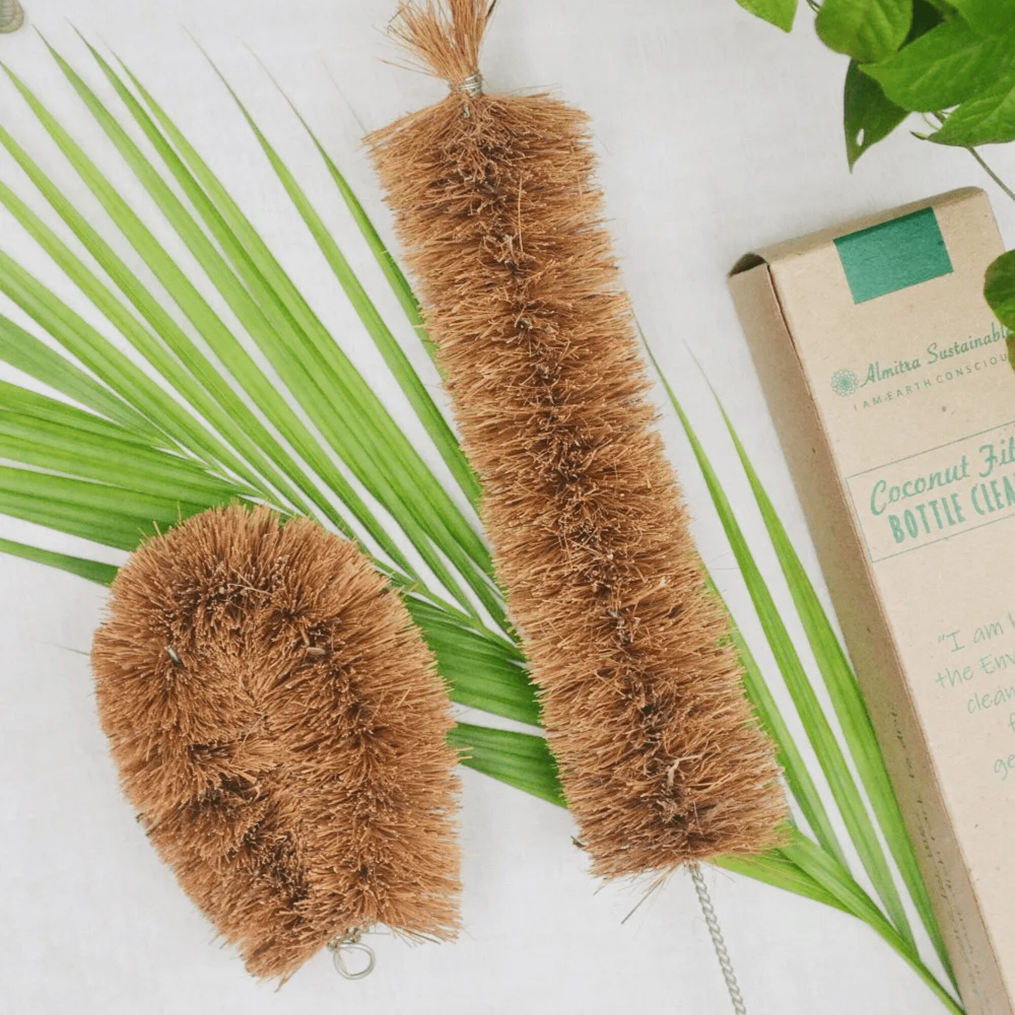Eco-friendly cleaning brush set with coconut fiber bottle cleaner and vegetable scrubber from Almitra Sustainables.